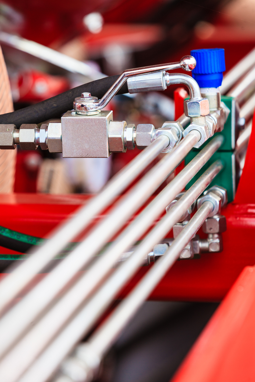 Hydraulic tubes, fittings and a valve installed on machinery